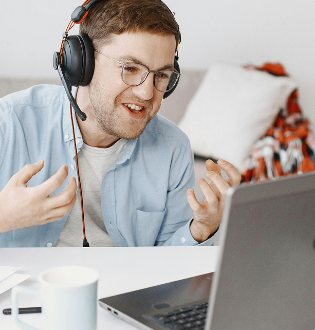 Man with headphones on talking excitedly on a meeting.