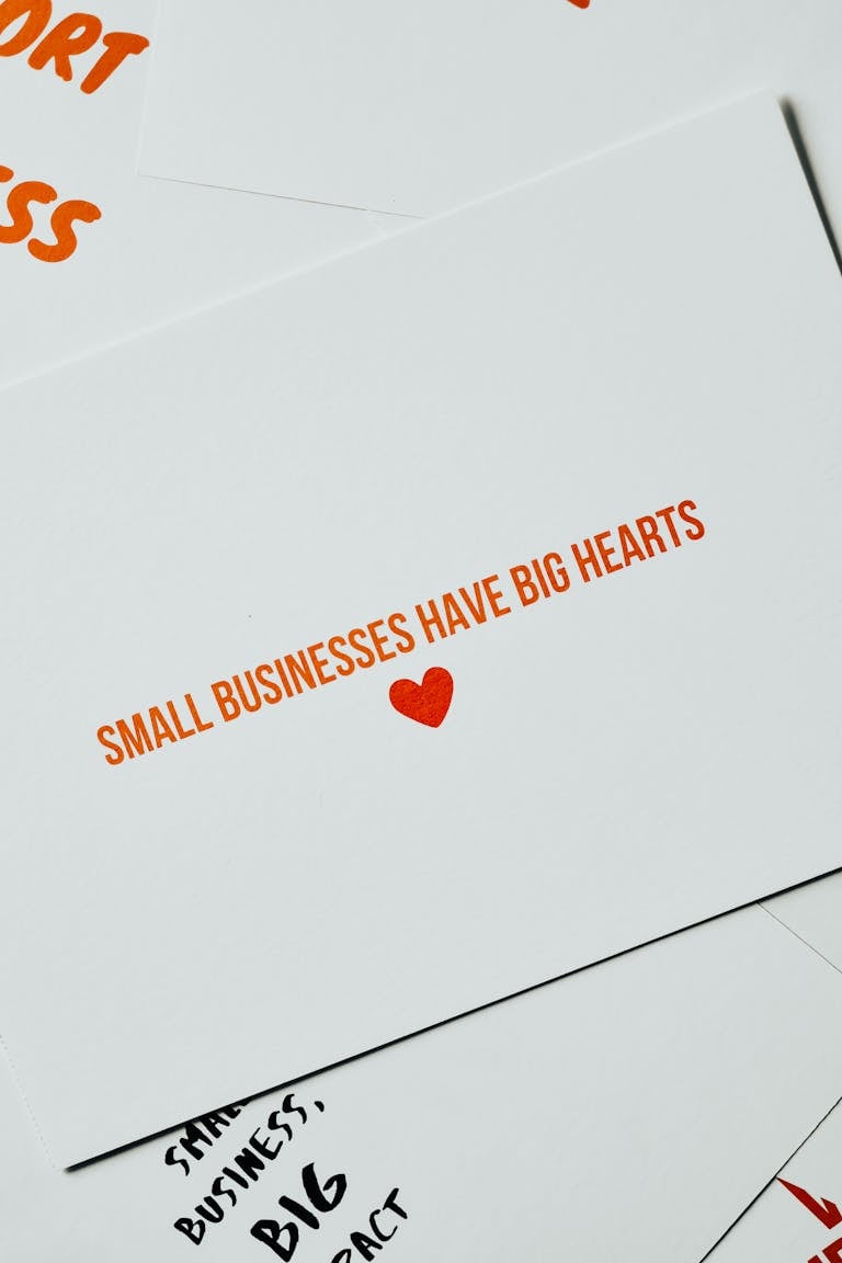 Card with 'Small Businesses Have Big Hearts' message in orange lettering on white background.