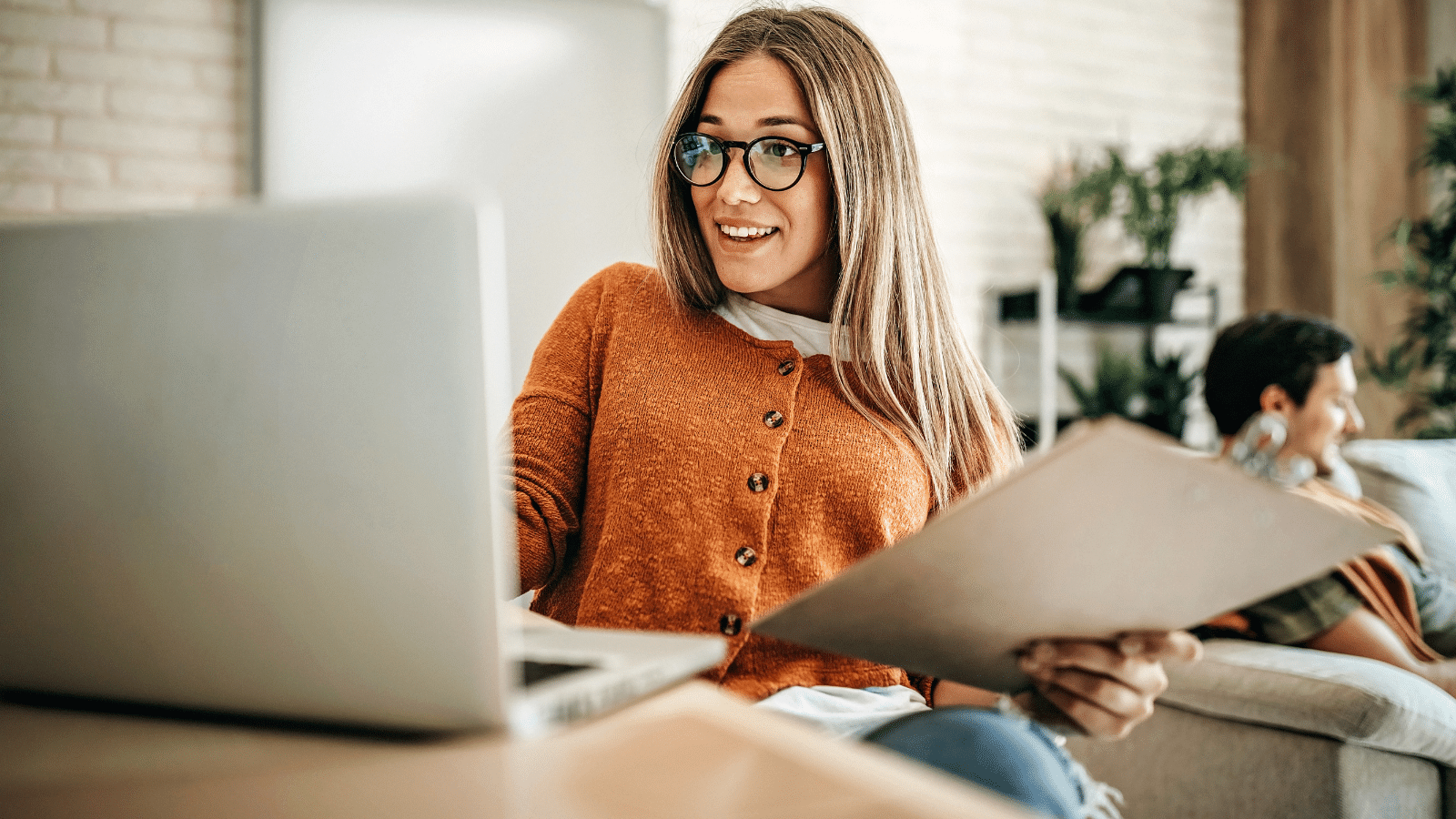 Business owner reviewing financial documents on laptop