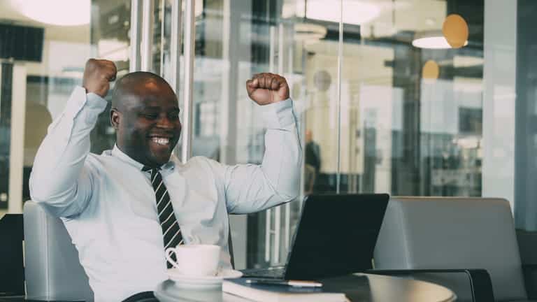 Happy businessman finally understanding how to read his books like a pro